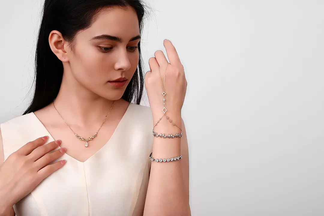 a jewelry model wearing a custom necklace and bracelet