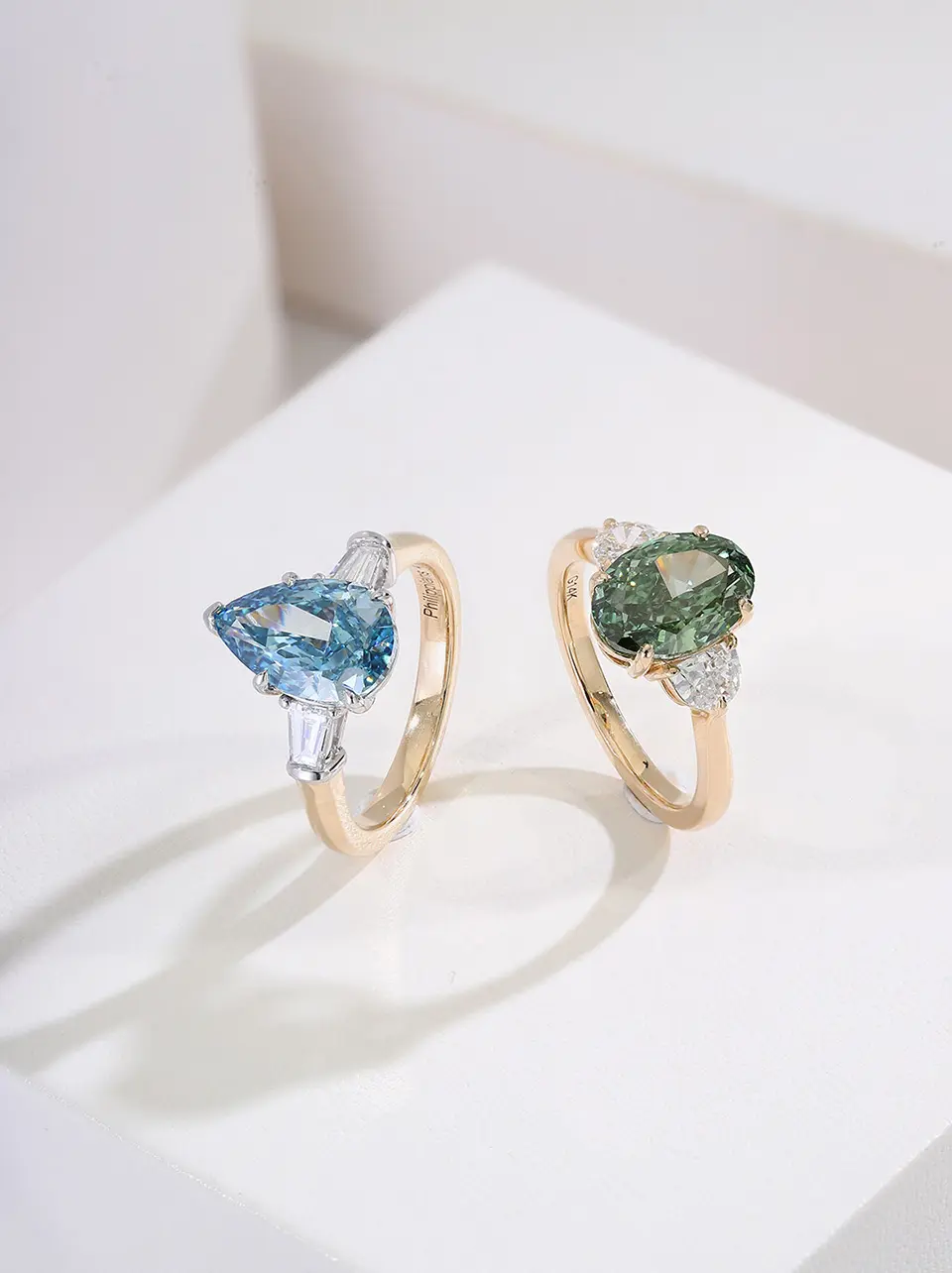 two colored lab diamond rings on box