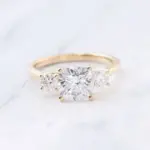 10k gold cushion moissanite prong set three stone engagement ring 1