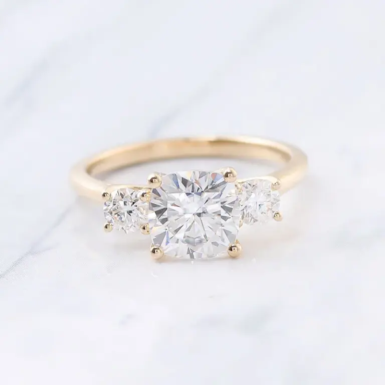 10k gold cushion moissanite prong set three stone engagement ring 1