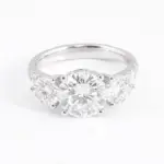 platinum round moissanite prong set three stone engagement ring 1