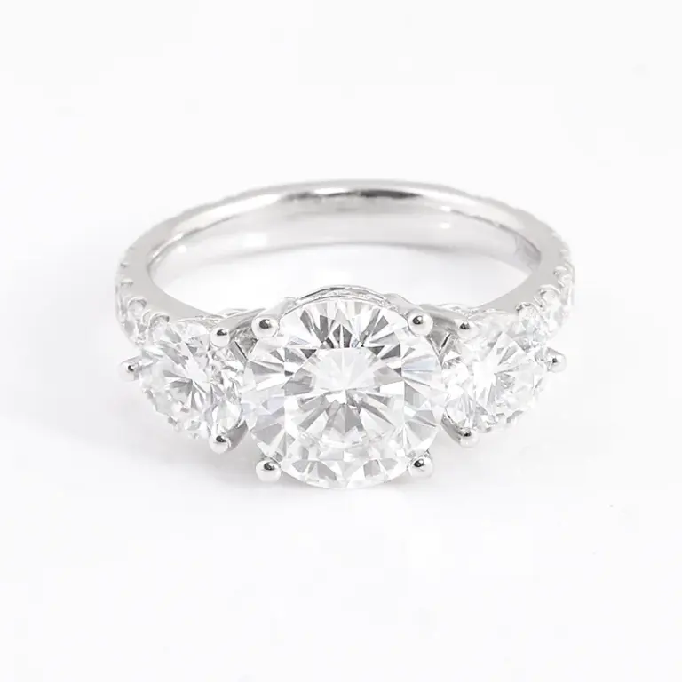 platinum round moissanite prong set three stone engagement ring 1