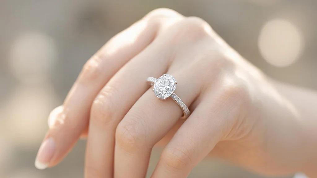 Oval cut diamond solitaire engagement ring with pavé band