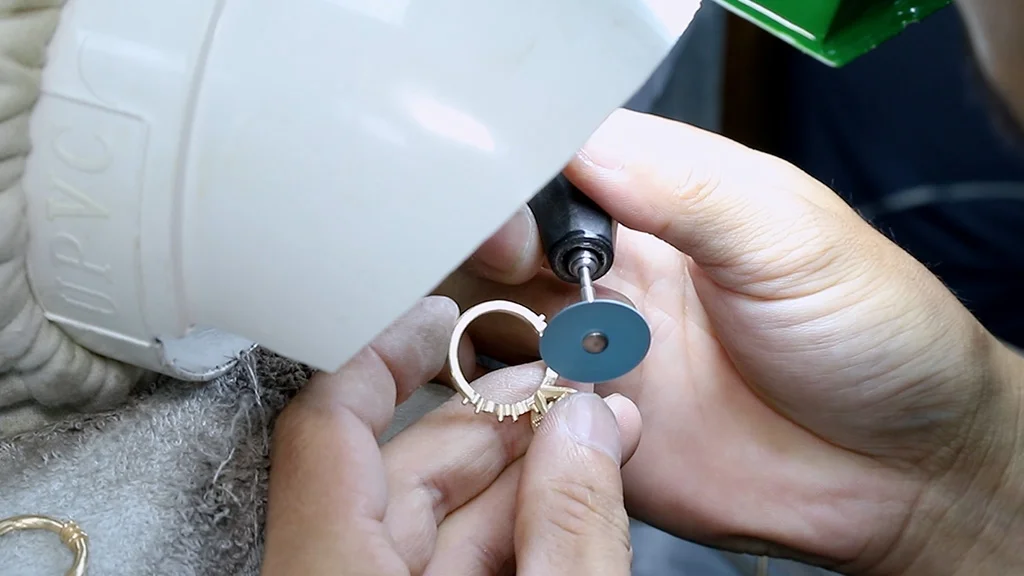 povence jewelry worker polishing a ring