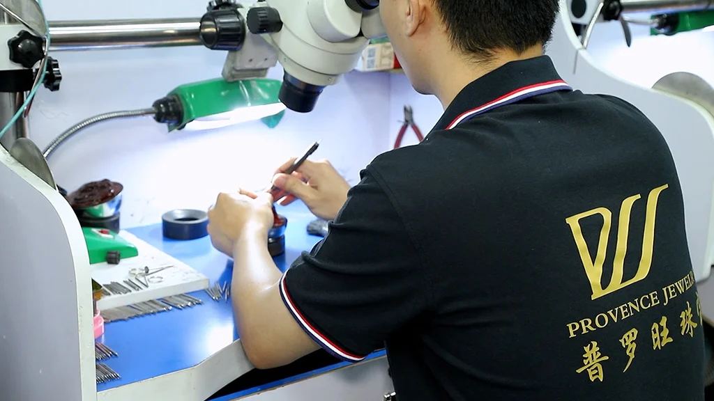 povence jewelry worker setting stone on a ring