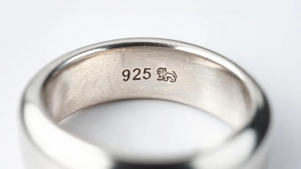 Close up of a 925 sterling silver hallmark stamp with lion passant mark inside a ring band
