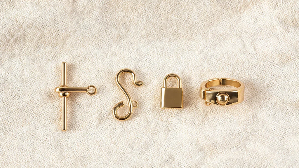 Four bracelet clasp types bolo slider, S hook, padlock clasp, and push button bangle catch