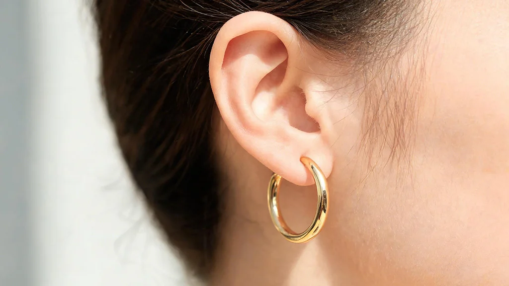 Gold hoop earring style close up