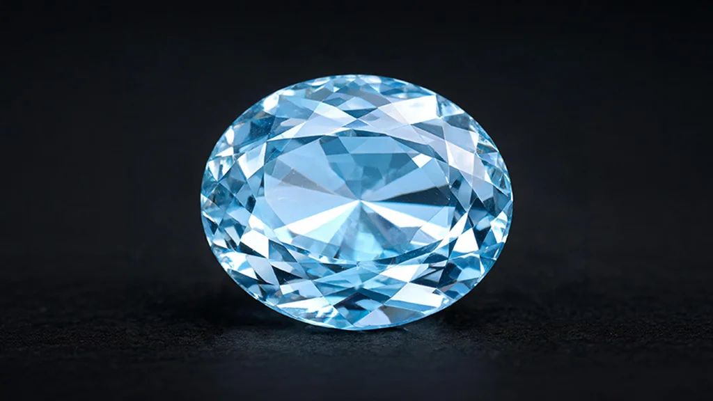 Macro close up of a faceted aquamarine gemstone showing its signature blue green color