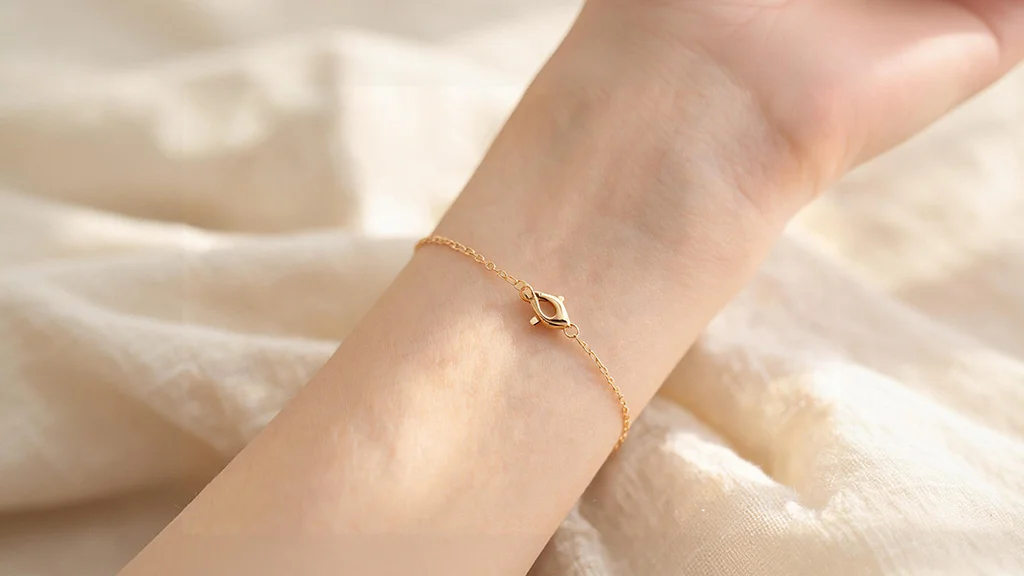 Woman's wrist wearing a gold chain bracelet showing the clasp closure