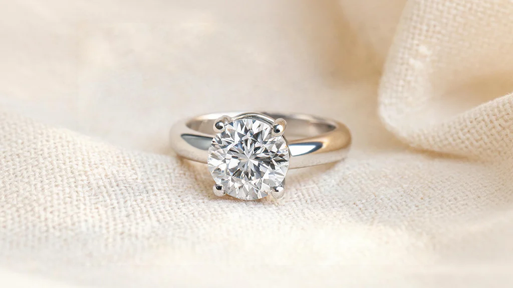 Close up of a white gold diamond ring showing both its bright rhodium plated shine and a hint of natural warm gold tone