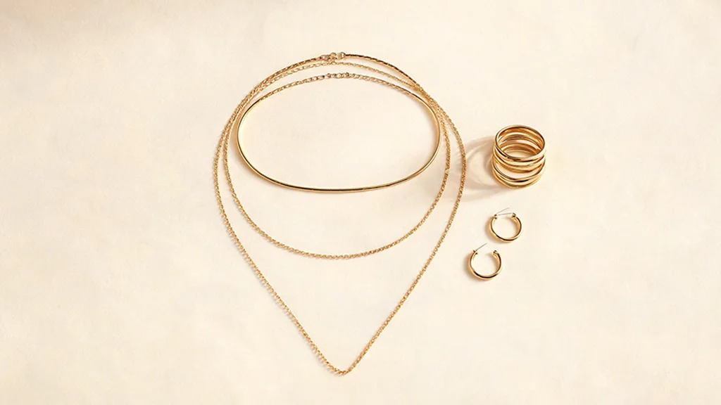 Layered gold necklaces and stacked rings demonstrating jewelry layering technique