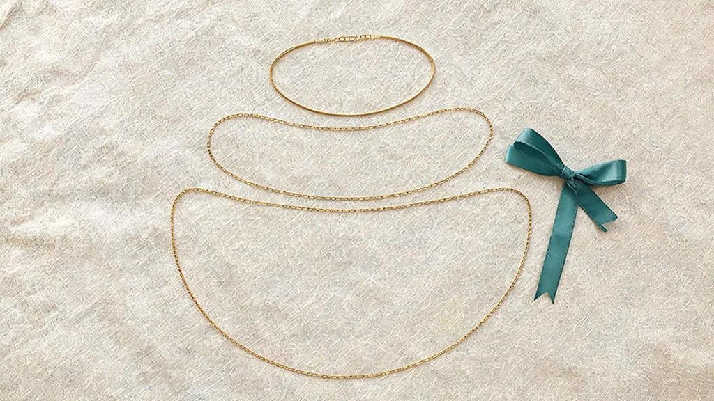 Three layered gold necklaces of increasing length demonstrating the necklace layering formula