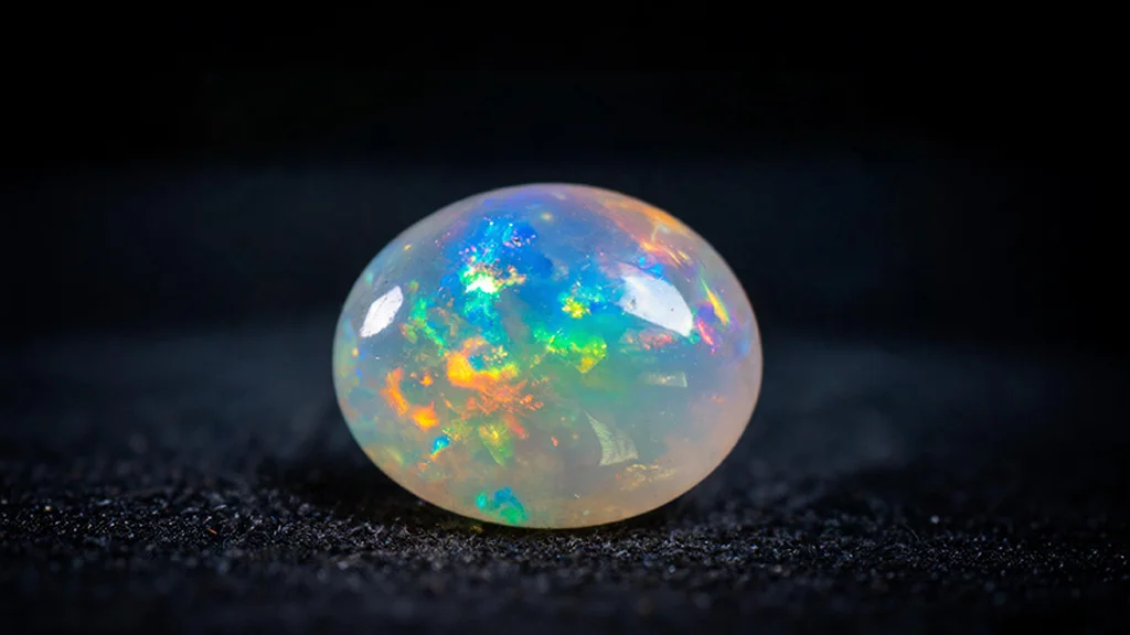 Close up of an opal gemstone showing rainbow play of color