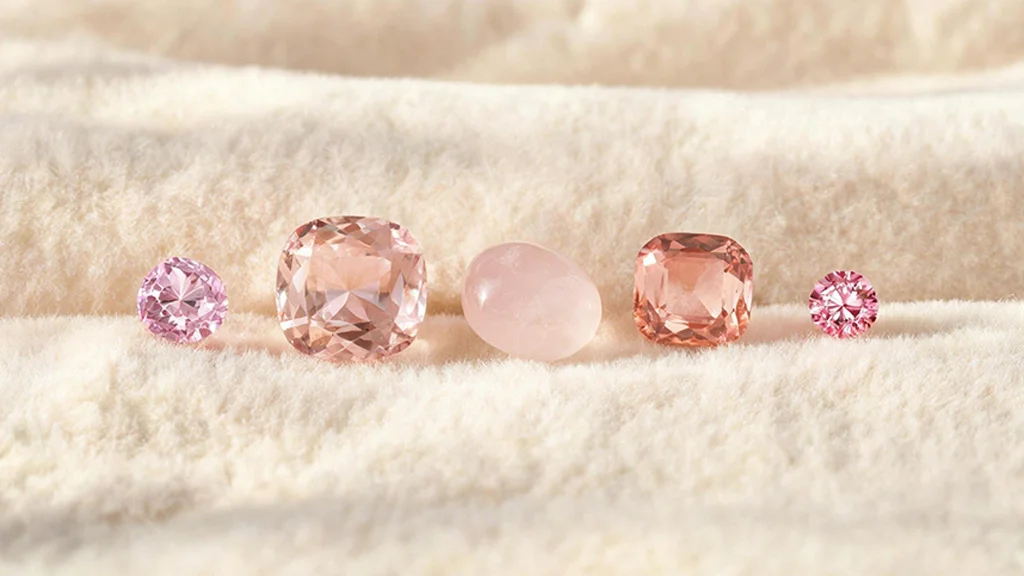 Collection of pink gemstones including sapphire, morganite, rose quartz, and tourmaline