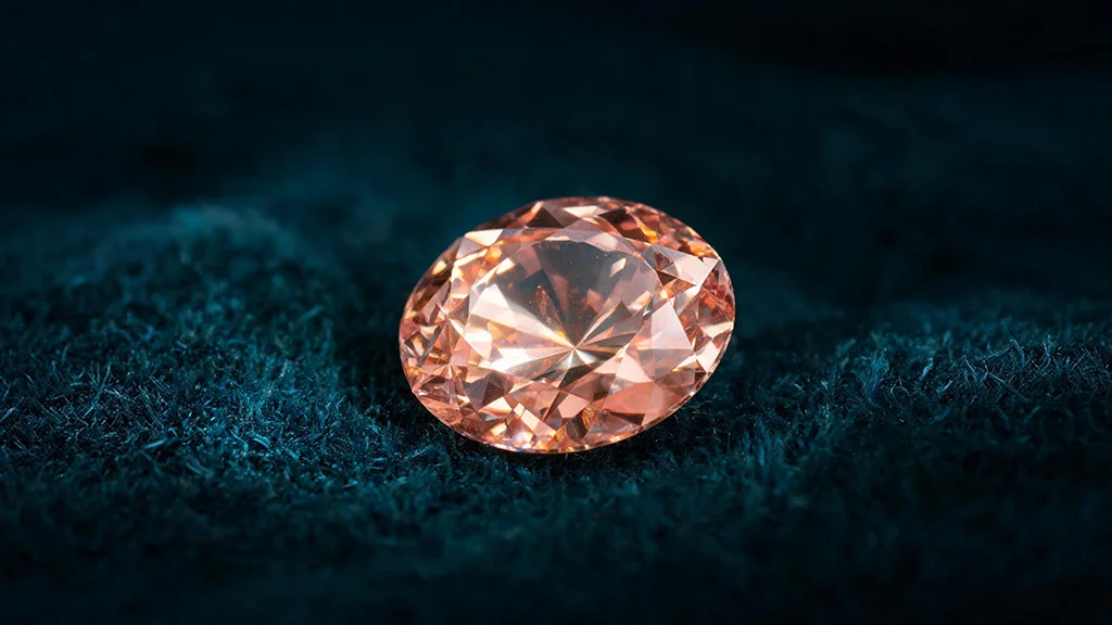 Faceted Imperial topaz gemstone showing its natural pinkish orange color