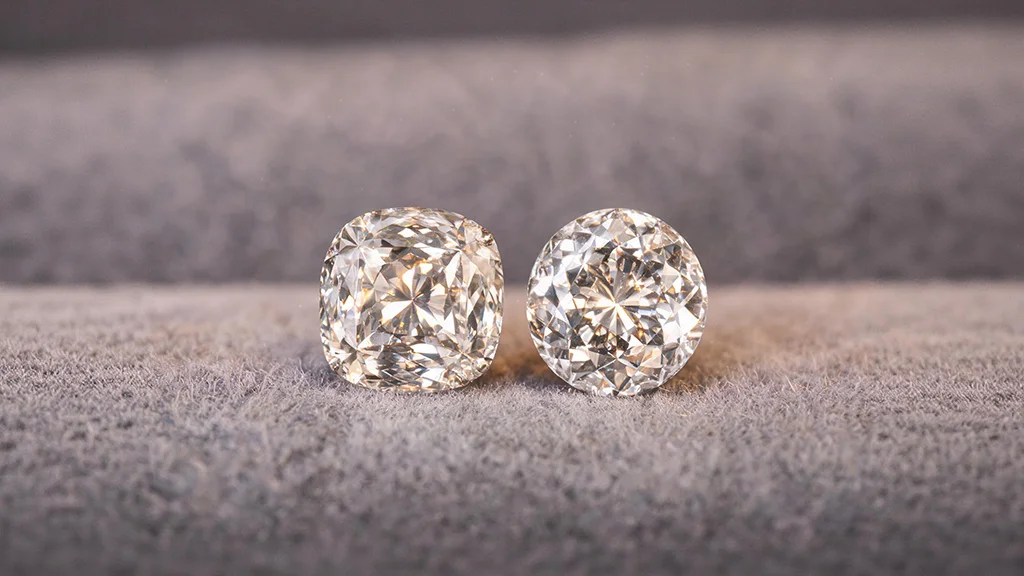 Old mine cut diamond next to an old European cut diamond showing the difference in outline shape
