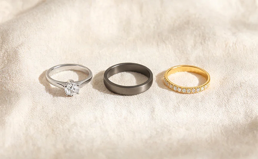 Platinum, titanium, and gold jewelry pieces arranged together, showing hypoallergenic jewelry metal options
